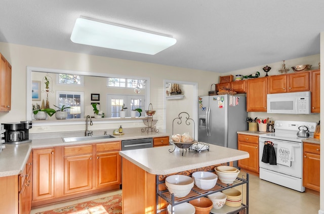 kitchen featuring a kitchen island, sink, stainless steel appliances, and french doors