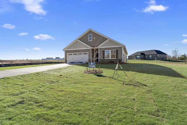 view of front of house featuring a front lawn and a garage