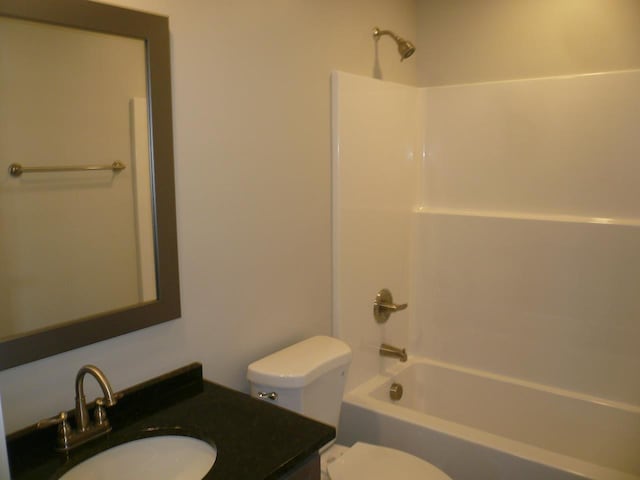 full bathroom featuring vanity, toilet, and washtub / shower combination