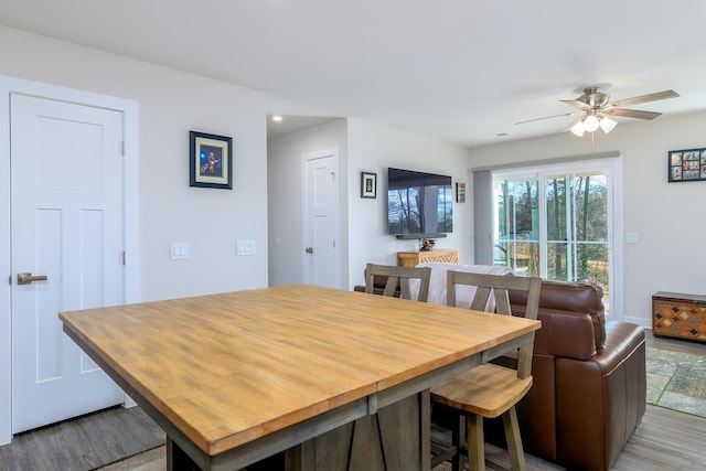 dining area with ceiling fan and light hardwood / wood-style flooring