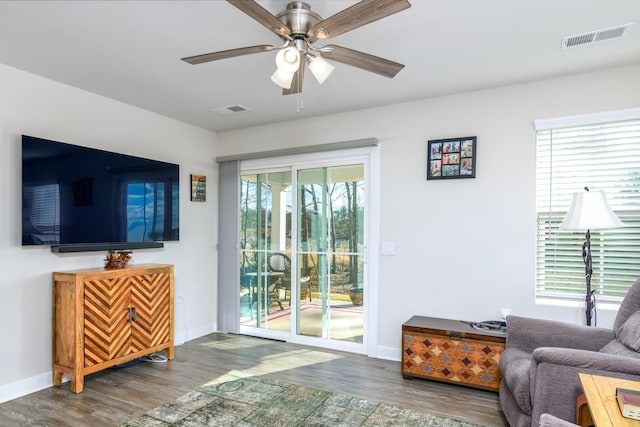 living room featuring ceiling fan and wood-type flooring