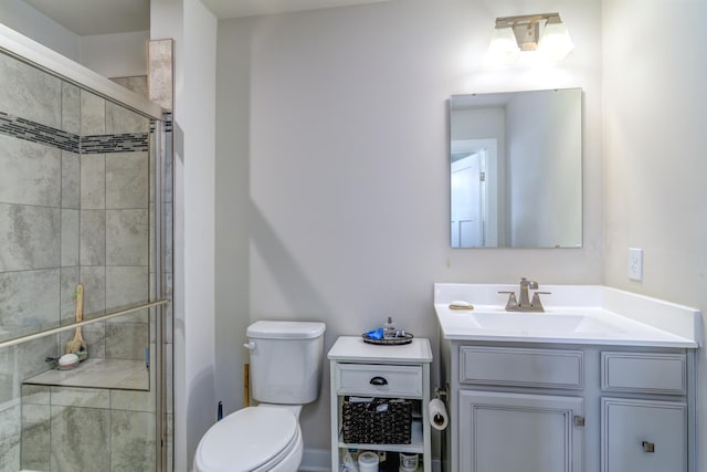 bathroom featuring vanity, toilet, and walk in shower