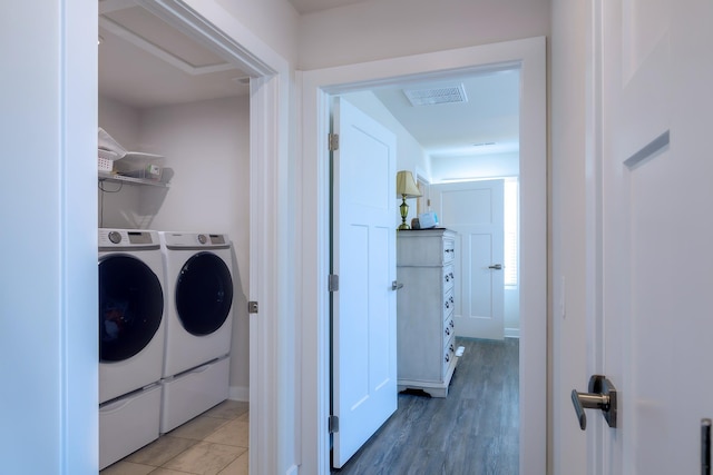 laundry room featuring wood-type flooring and independent washer and dryer