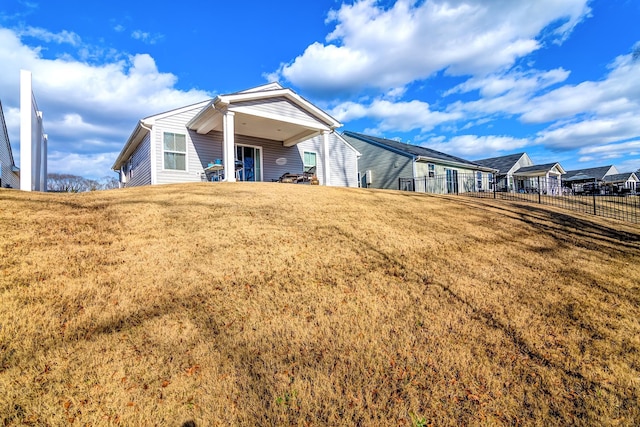 rear view of property featuring a yard