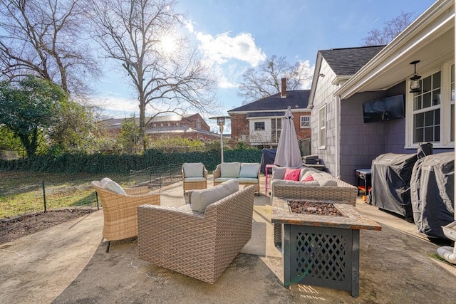 view of patio / terrace with area for grilling and an outdoor living space with a fire pit