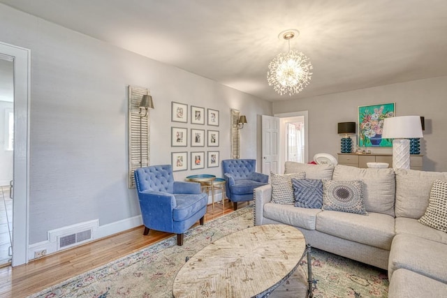 living room with a chandelier and wood-type flooring