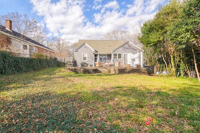 back of property with a lawn and a patio