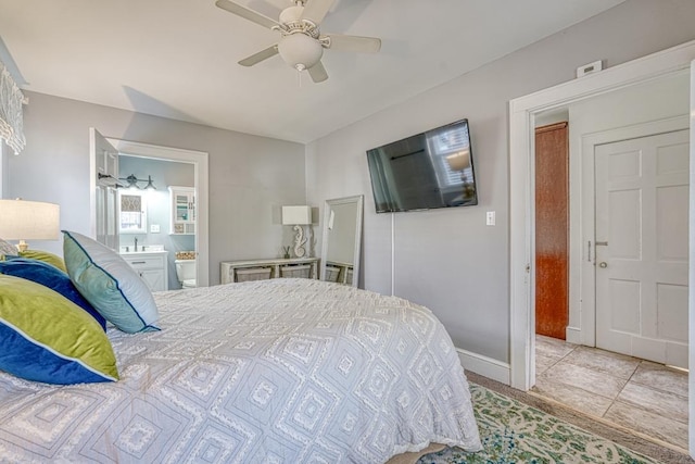 tiled bedroom featuring connected bathroom and ceiling fan