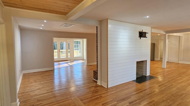 hallway with beamed ceiling and light hardwood / wood-style flooring