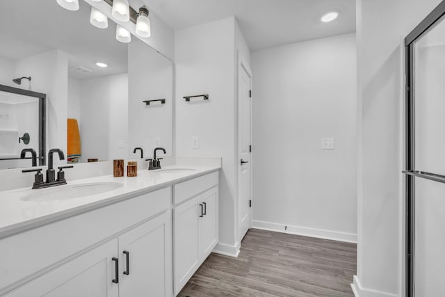 bathroom with hardwood / wood-style floors and vanity