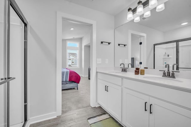 bathroom with vanity, wood-type flooring, and walk in shower