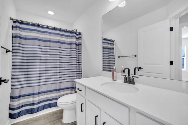 bathroom featuring hardwood / wood-style floors, vanity, and toilet