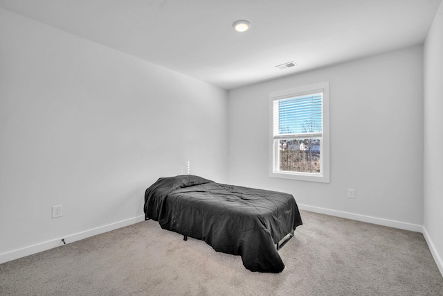 bedroom with light colored carpet