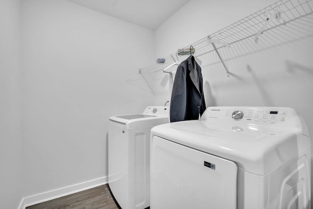 laundry room with dark hardwood / wood-style floors and washer and clothes dryer