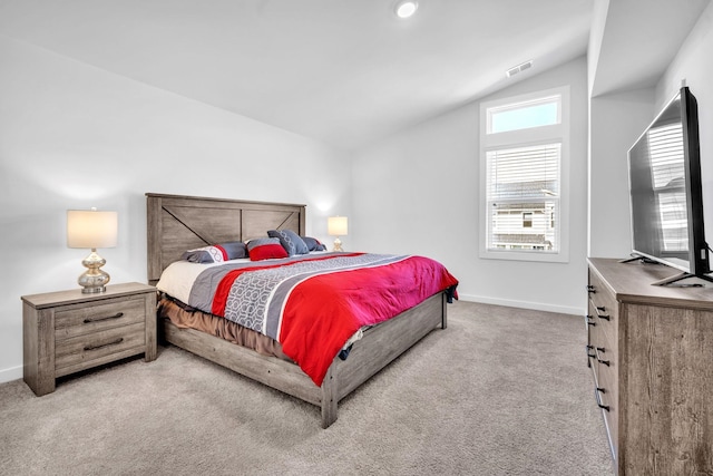 bedroom featuring light carpet and vaulted ceiling