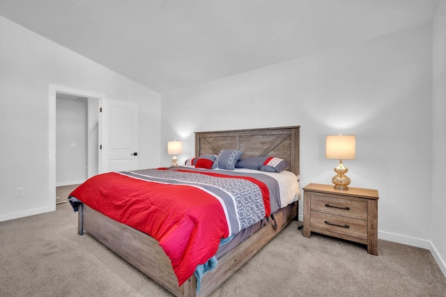 bedroom featuring light carpet and vaulted ceiling