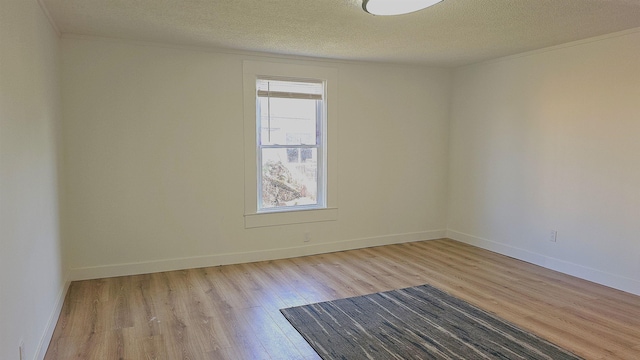 unfurnished room with a textured ceiling and light wood-type flooring