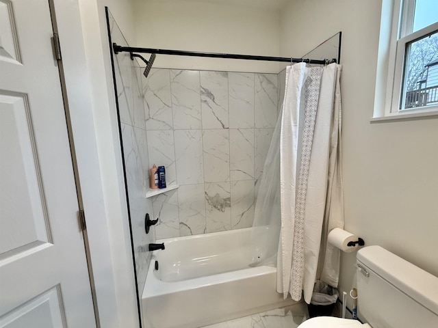 bathroom with shower / bath combination with curtain and toilet