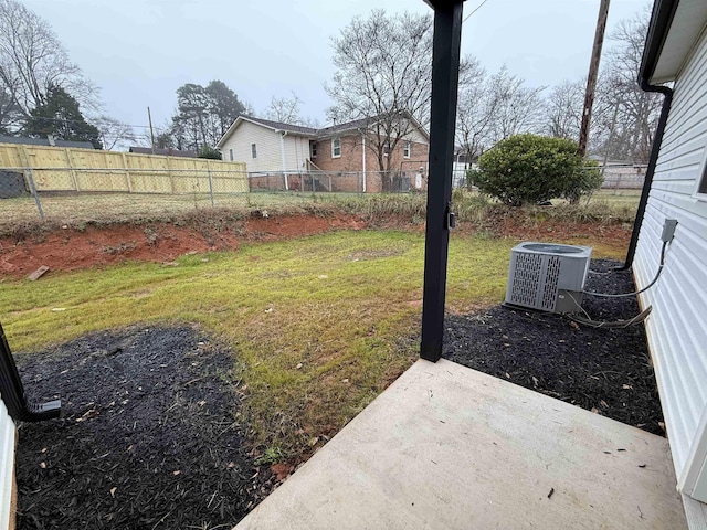 view of yard with central air condition unit and a patio