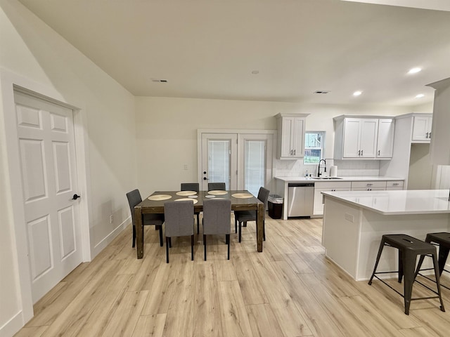 dining room with light hardwood / wood-style floors and sink