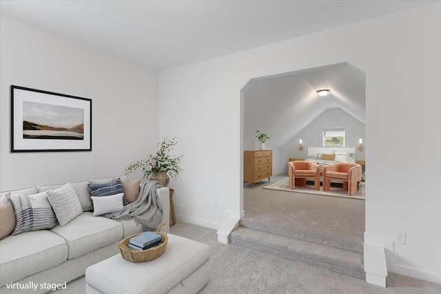 carpeted living room with lofted ceiling