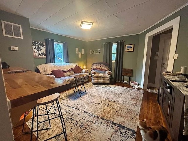 living room with hardwood / wood-style floors and ornamental molding