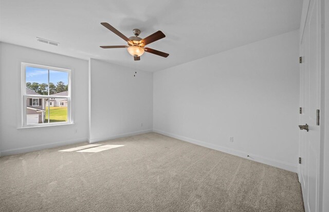 carpeted empty room featuring ceiling fan