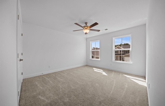 carpeted spare room featuring ceiling fan