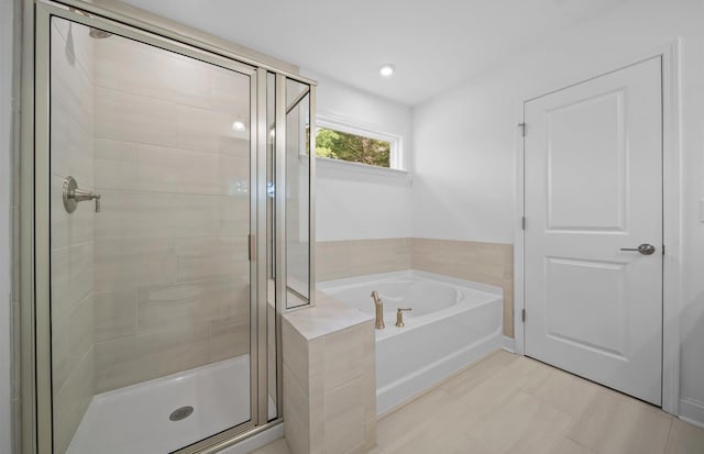 bathroom with tile patterned floors and separate shower and tub