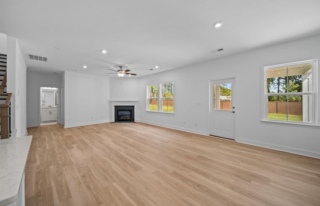 unfurnished living room with light hardwood / wood-style floors and ceiling fan