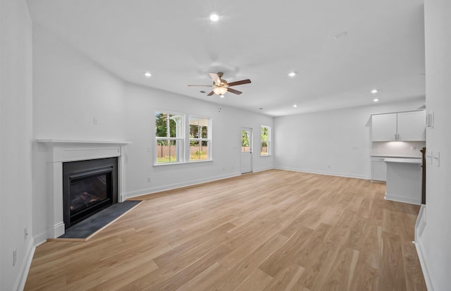 unfurnished living room with ceiling fan and light hardwood / wood-style flooring