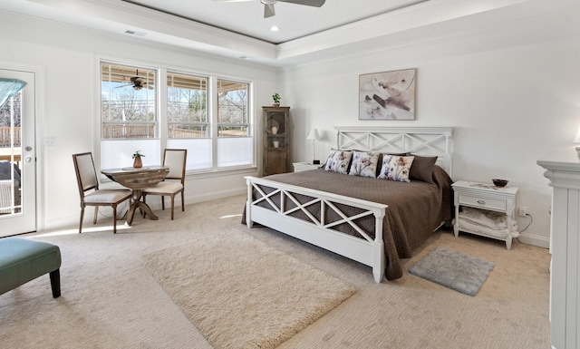 bedroom featuring access to outside, carpet floors, a tray ceiling, and ceiling fan