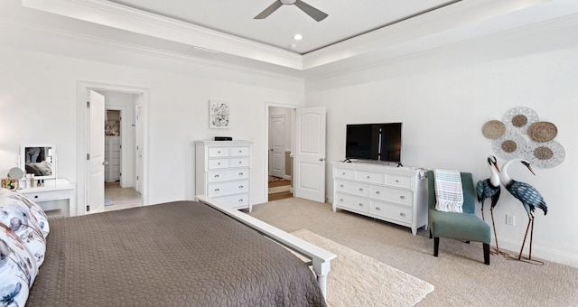 bedroom featuring a tray ceiling, ceiling fan, light carpet, and ornamental molding