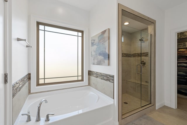 bathroom featuring plus walk in shower