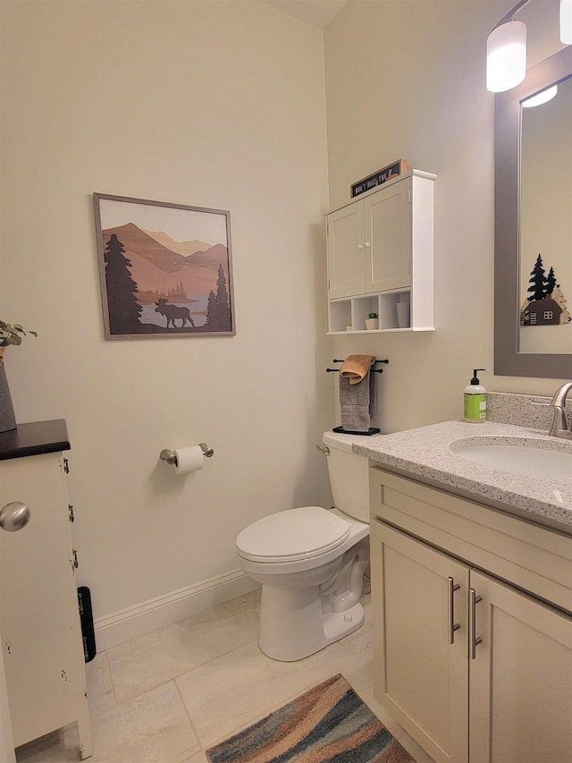 bathroom with tile patterned floors, vanity, and toilet