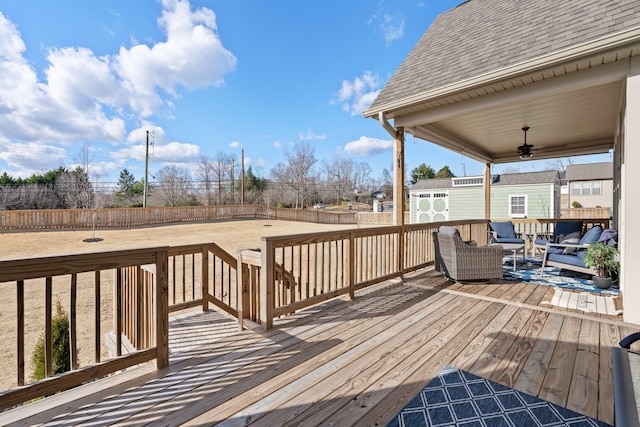 wooden deck with ceiling fan and an outdoor living space