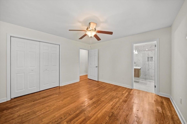 unfurnished bedroom with ensuite bath, ceiling fan, a closet, and light hardwood / wood-style flooring