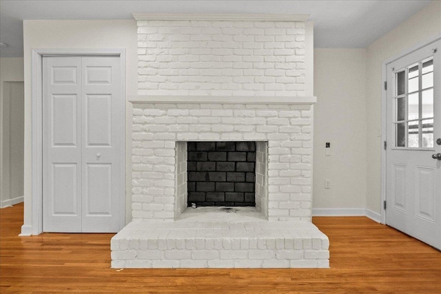 room details with hardwood / wood-style flooring and a fireplace