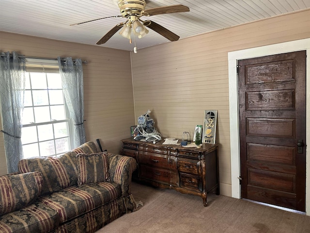 living area featuring ceiling fan and carpet floors