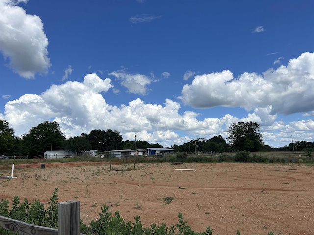 view of yard with a rural view