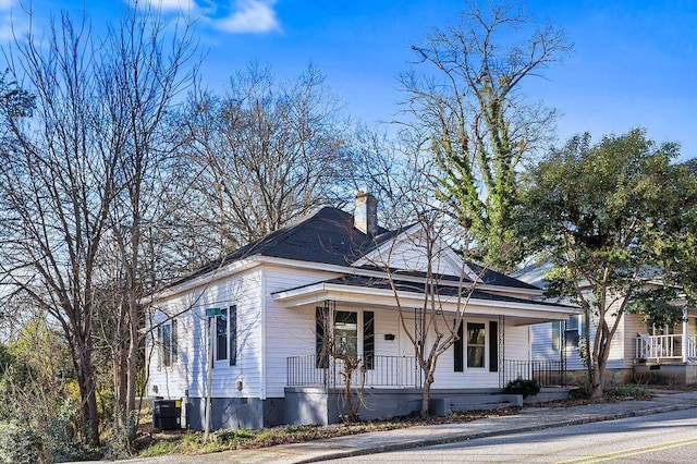 bungalow featuring a porch and cooling unit