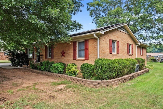 view of side of home featuring a yard