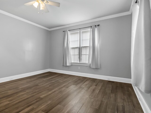 empty room with ceiling fan, dark hardwood / wood-style flooring, and ornamental molding