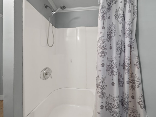 bathroom with crown molding and shower / bath combo