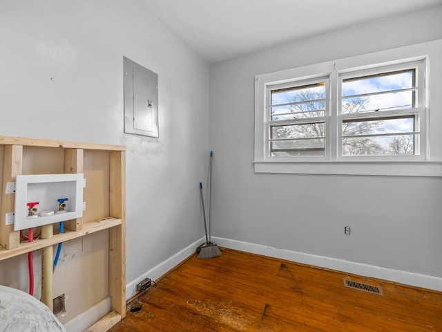 laundry room featuring washer hookup, dark hardwood / wood-style flooring, and electric panel