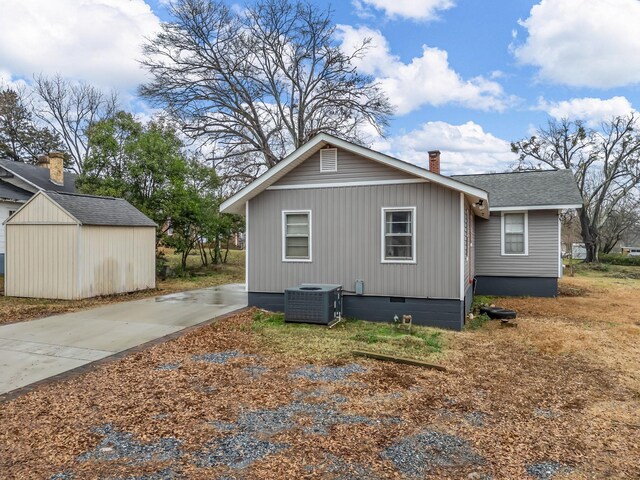 view of side of property featuring an outbuilding and central AC unit