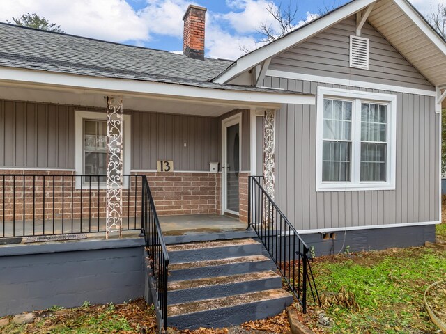 view of exterior entry with covered porch