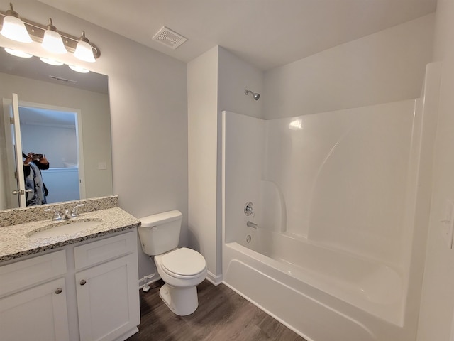 full bathroom featuring wood-type flooring, vanity, toilet, and shower / tub combination