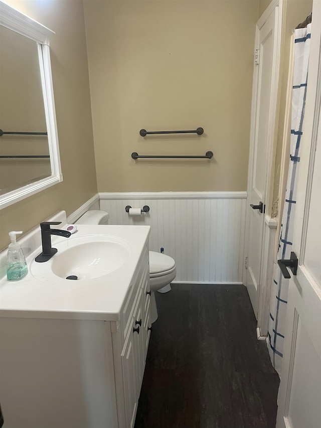 bathroom featuring hardwood / wood-style floors, vanity, and toilet