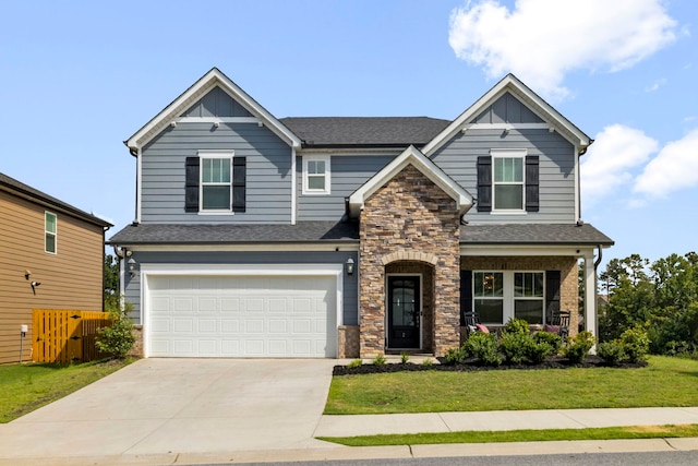 craftsman inspired home with a front yard and a garage